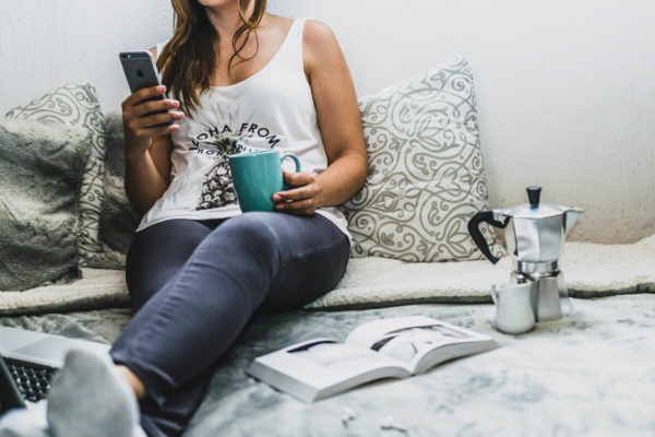 A woman holding her smartphone and relaxing